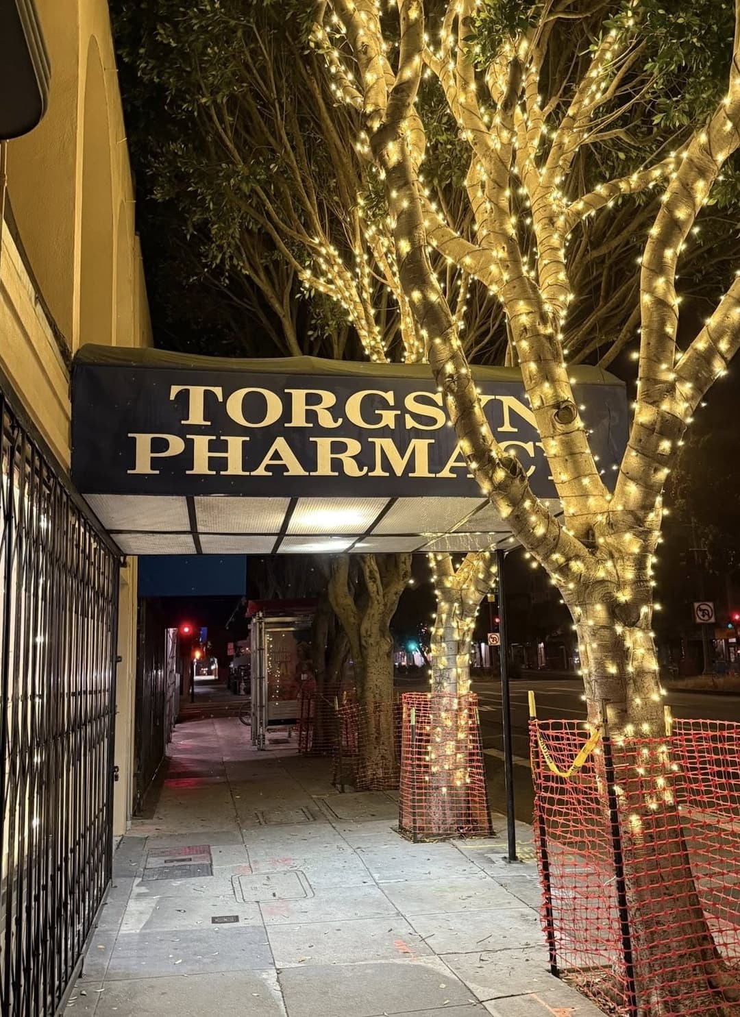 Pharmacist at Torgsyn Discount Pharmacy smiling while assisting a patient.